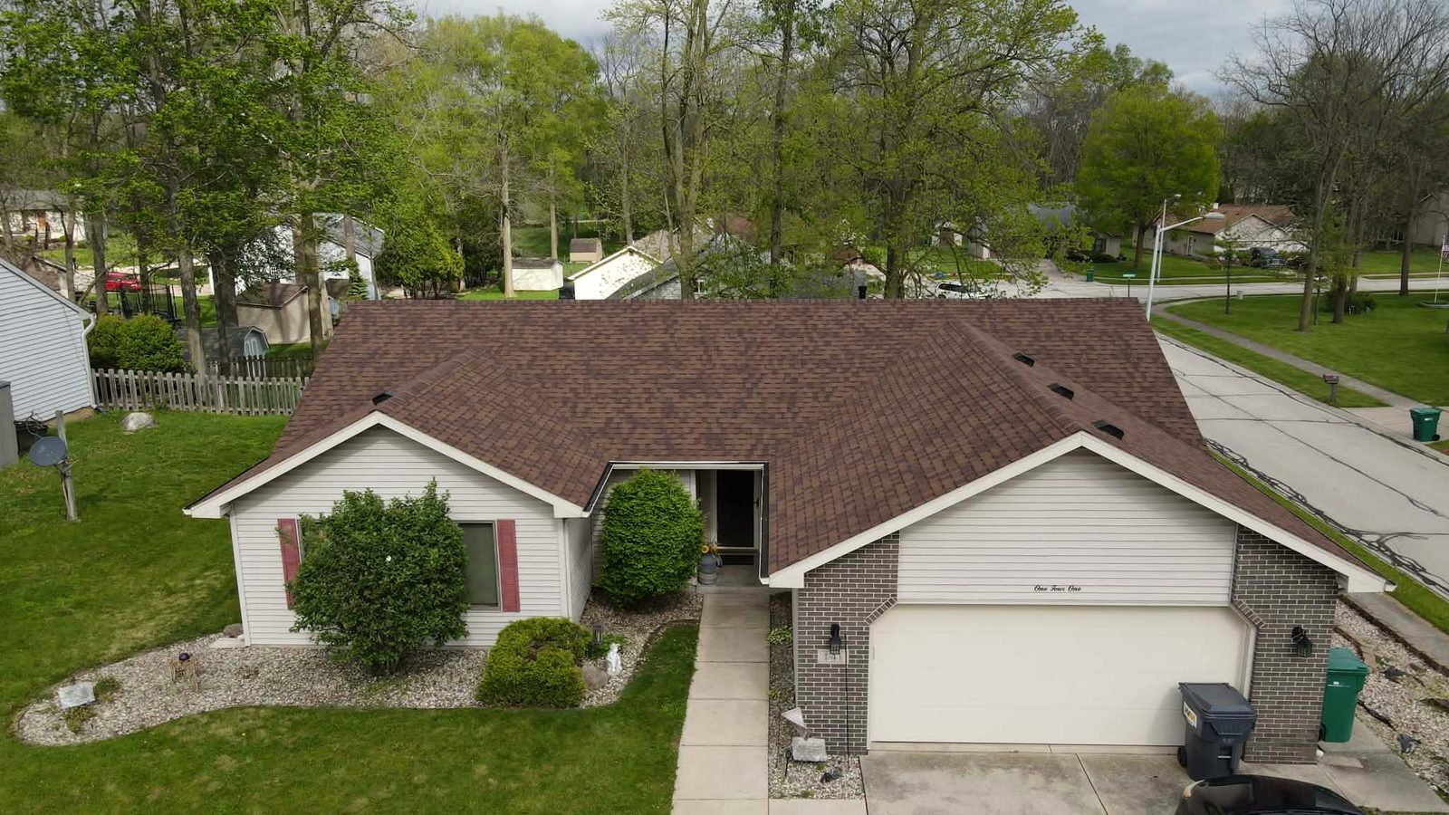 Finished brown shingle roof on a ranch home, drone view