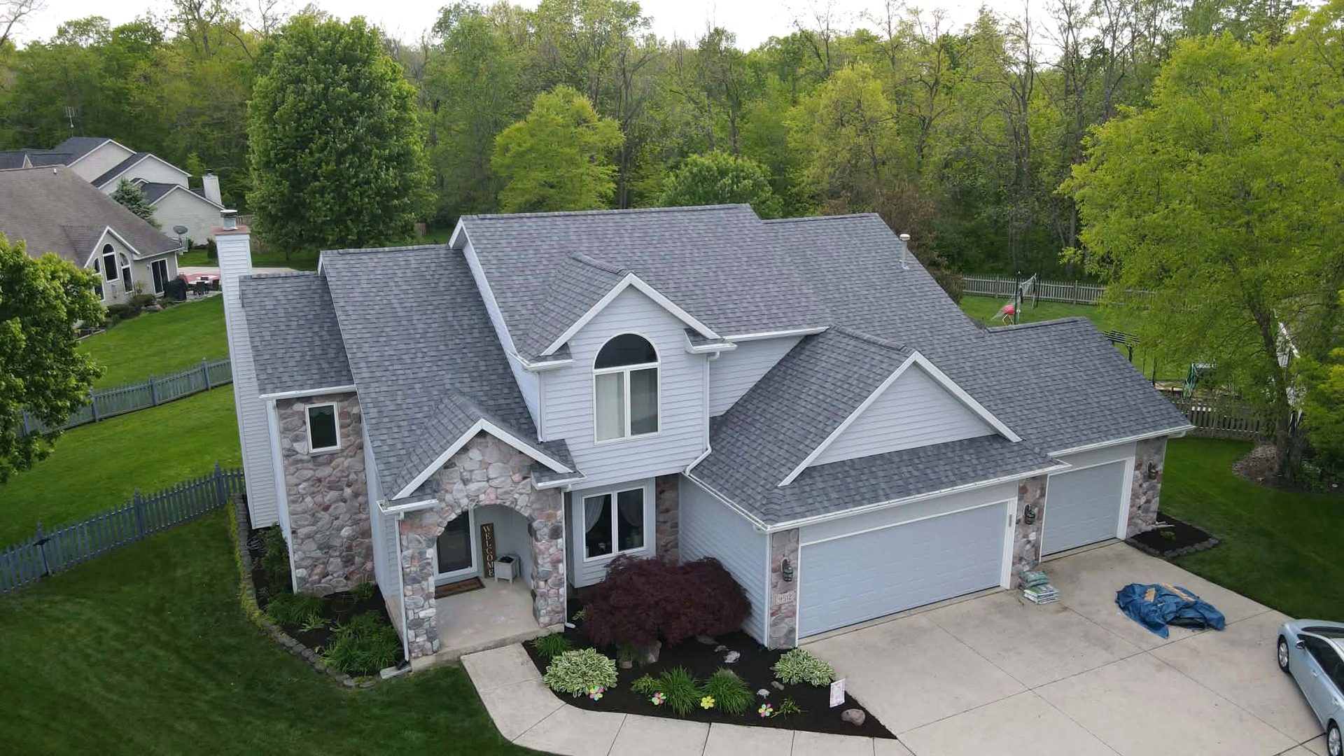 A finished gray architectural shingle roof on a two story home in Allen County, Indiana